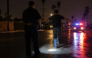 Field Sobriety Test Traffic Stop Orange County - DUI Lawyer Orange County Police officer administering a field sobriety test during a nighttime DUI stop in Orange County